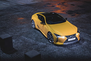 yellow Lexus 500 coupe on black top road HD wallpaper