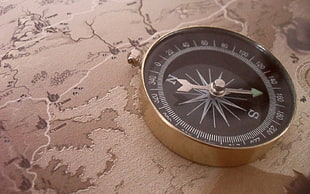 round black and silver-colored compass