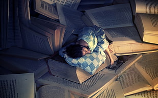 woman sleeping with giant books