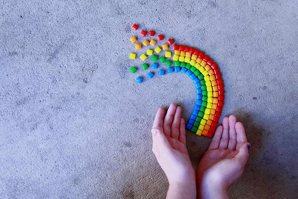 person hand beside assorted color beads HD wallpaper