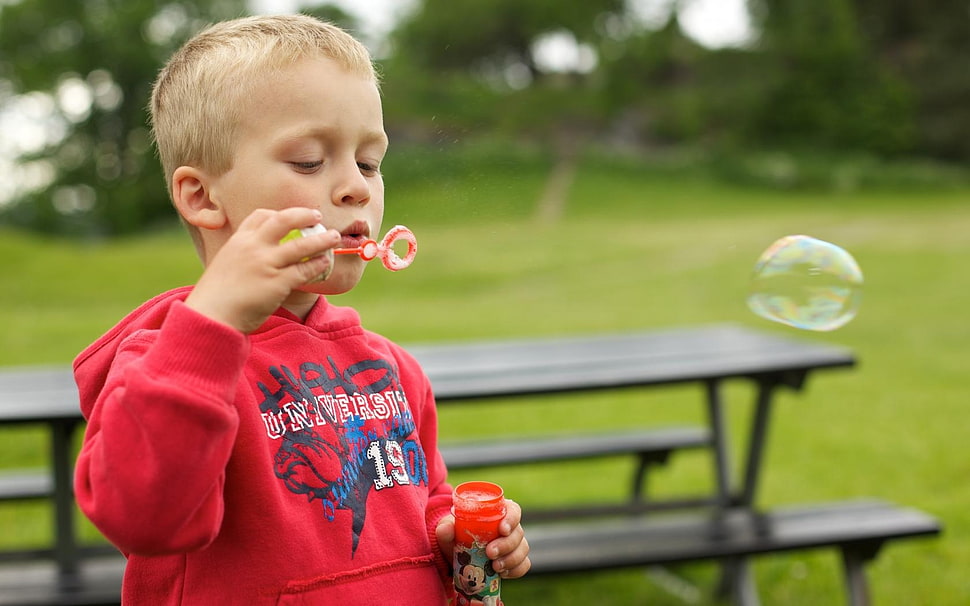 boy wearing red jacket playing bubbles HD wallpaper