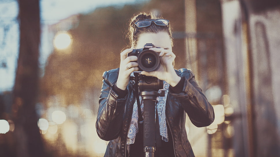 woman taking photo using black camera body at daytime HD wallpaper