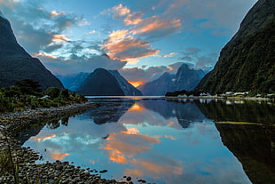 landscape photography of calm water in between mountains
