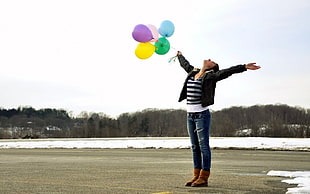 woman holding balloons during day time HD wallpaper