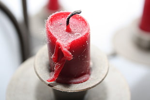 selective focus photo of red pillar candle on brown stand HD wallpaper