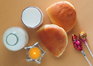 baked bread beside milk glasses