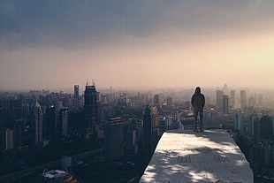man standing on top of a building HD wallpaper