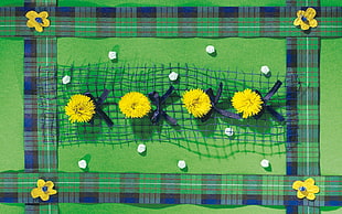 green textile with yellow petaled flower design
