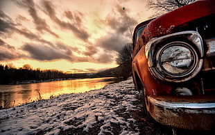 red car parked near river during sunset HD wallpaper