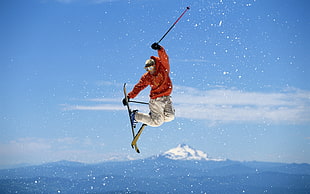 painting of man jumping while in ski gears