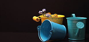photography of three assorted plastic pails