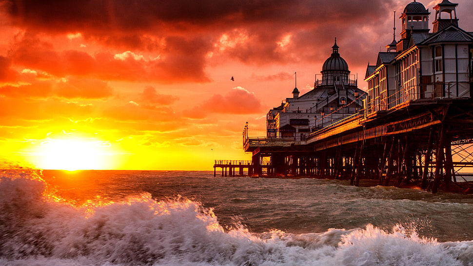 white house under grey clouds during golden hour HD wallpaper