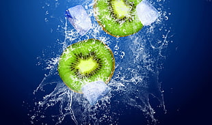 two sliced kiwi fruit submerge in water