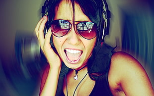 woman wearing aviator-style sunglasses and corded headset