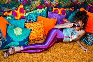 woman wearing purple leggings lying side pillow