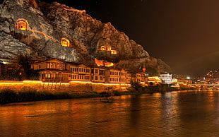golden city during night time, rock, building, coast, night