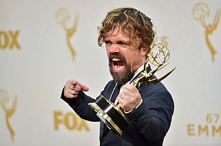 Game of Thrones character holding trophy