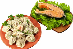 cooked dumplings and sliced fish with lettuce