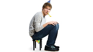man sitting on small chair