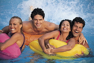 group of people at the pool with floaters