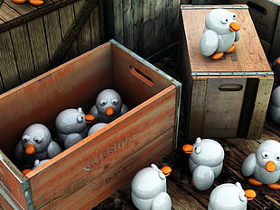gray penguin toy lot in brown wooden crate