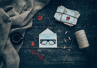 flat lay photography of eyeglasses on envelope