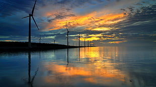 gray windmills, water, landscape, sunlight, reflection