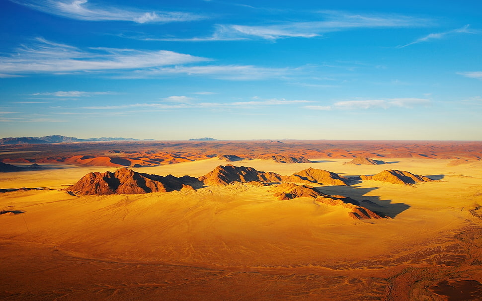 aerial photography of desert field under sunny sky HD wallpaper
