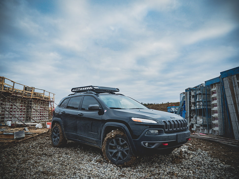 black Jeep SUV surrounded by blue steel scaffolding HD wallpaper