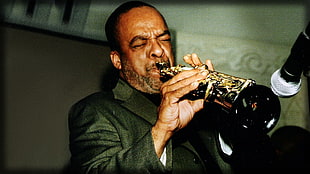 man in black suit playing trumpet HD wallpaper