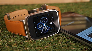 silver aluminum case Apple Watch with brown leather strap on grass HD wallpaper