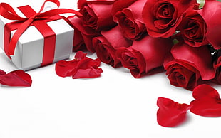 bunch of red Roses beside gift box