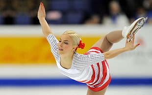 woman wearing white and red striped dress figure skating