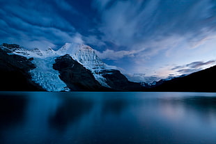 landscape photography of snow coated mountain surrounded by body of water, berg lake