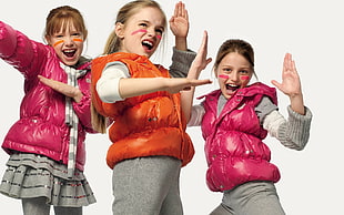 three girls wearing pink and orange bubble vest zip-up hooded jackets
