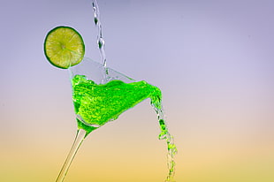 timelapse photography of water pour on green cocktail drink