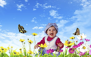 baby on flower field at daytime