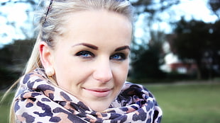 selective focus photography of woman in leopard print scarf