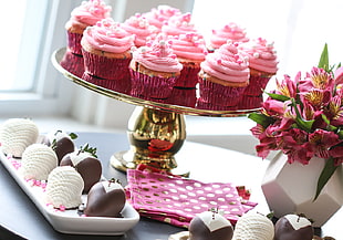 pink cupcakes in brass metal tray, strawberries, shari