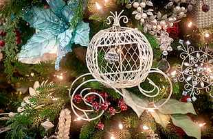 white metal Christmas candle holder near string lights