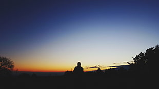 silhouette of person standing during golden hour