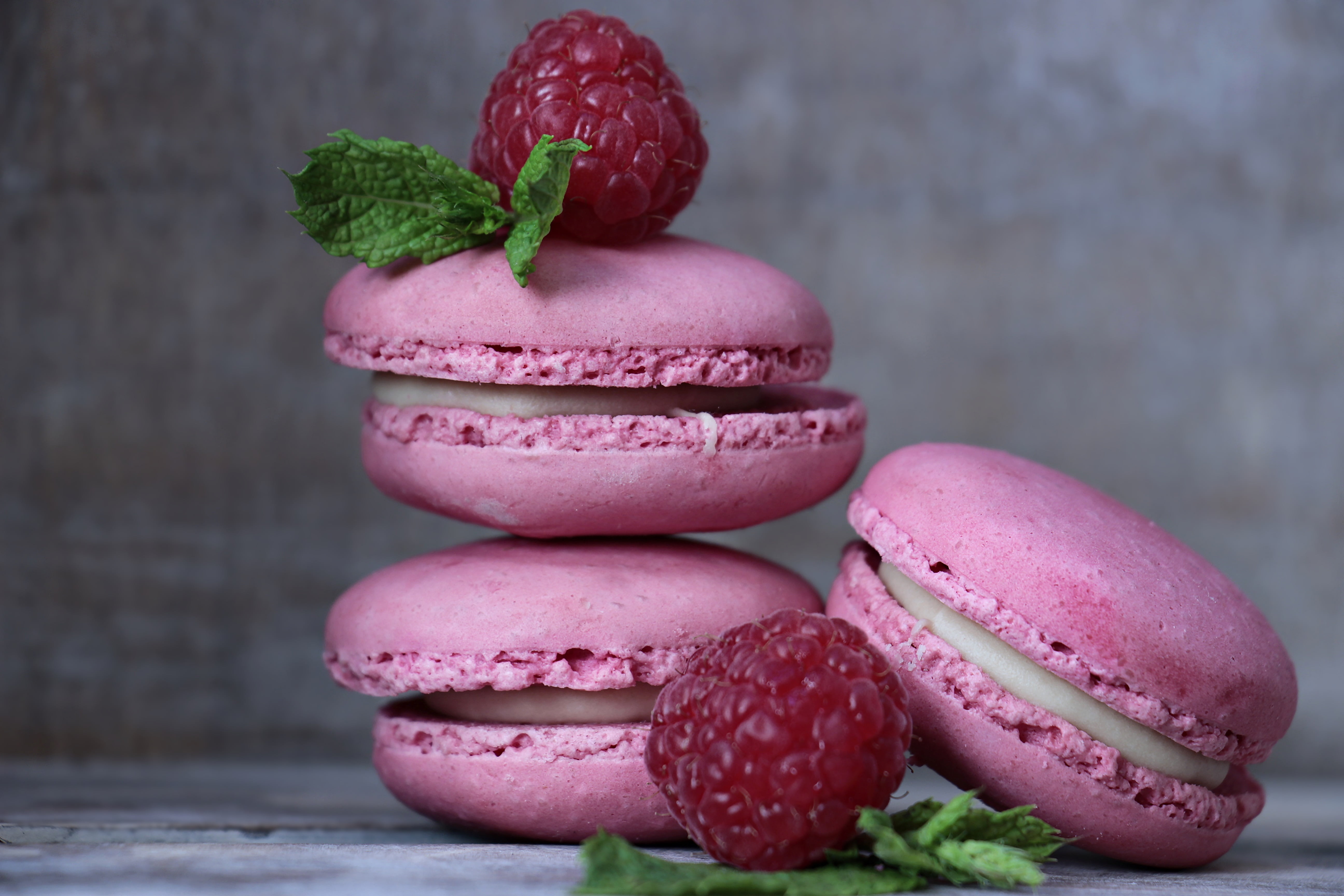 three pink  macarons  and raspberry