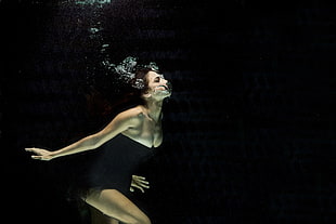 shallow focus photography of woman in black clothes underwater photography