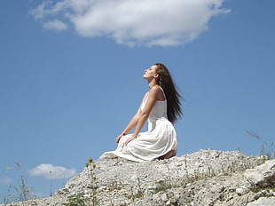 woman kneeling in a gray rocky ground