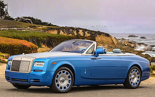 blue convertible coup near mountain and river