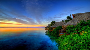 several thatch roof houses, sea, sunset, hut, sky HD wallpaper