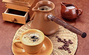 brown ceramic cezve coffeepot and beige ceramic mug