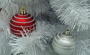 two red and gray Christmas balls hanged on white Christmas tree