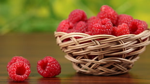 raspberry fruits on wicker brown basket