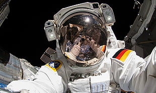 astronaut taking selfie in outer space